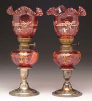 Appraisal: PAIR OF CRANBERRY PEG LAMPS Unlisted Cranberry shades and fonts