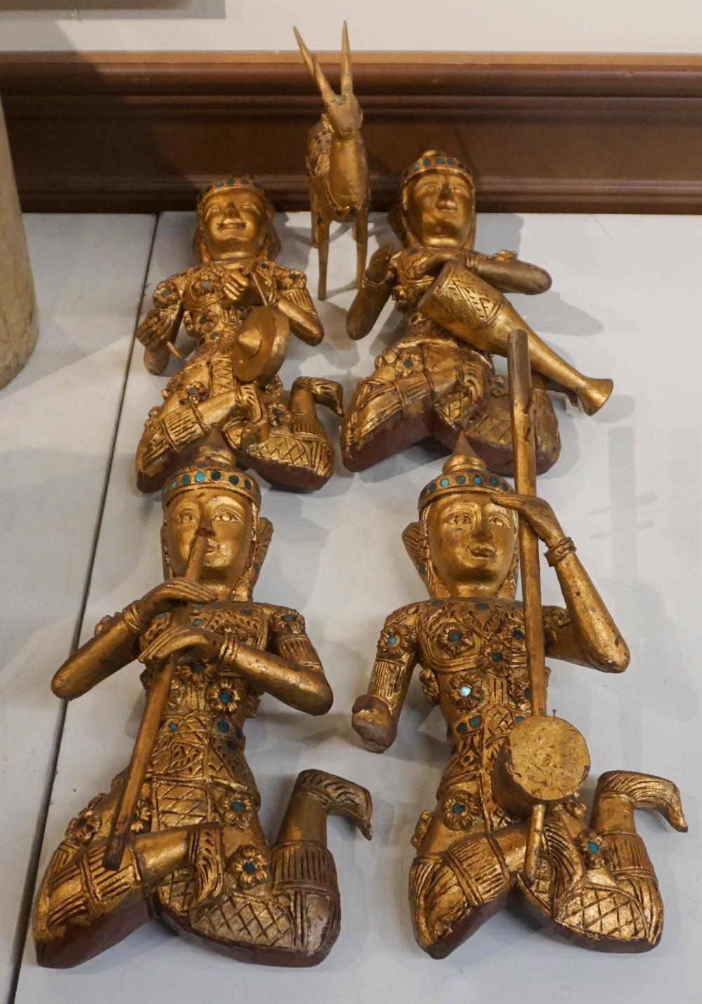 Appraisal: FOUR THAI GILT AND JEWELED WOOD FIGURES OF MUSICIANS AND