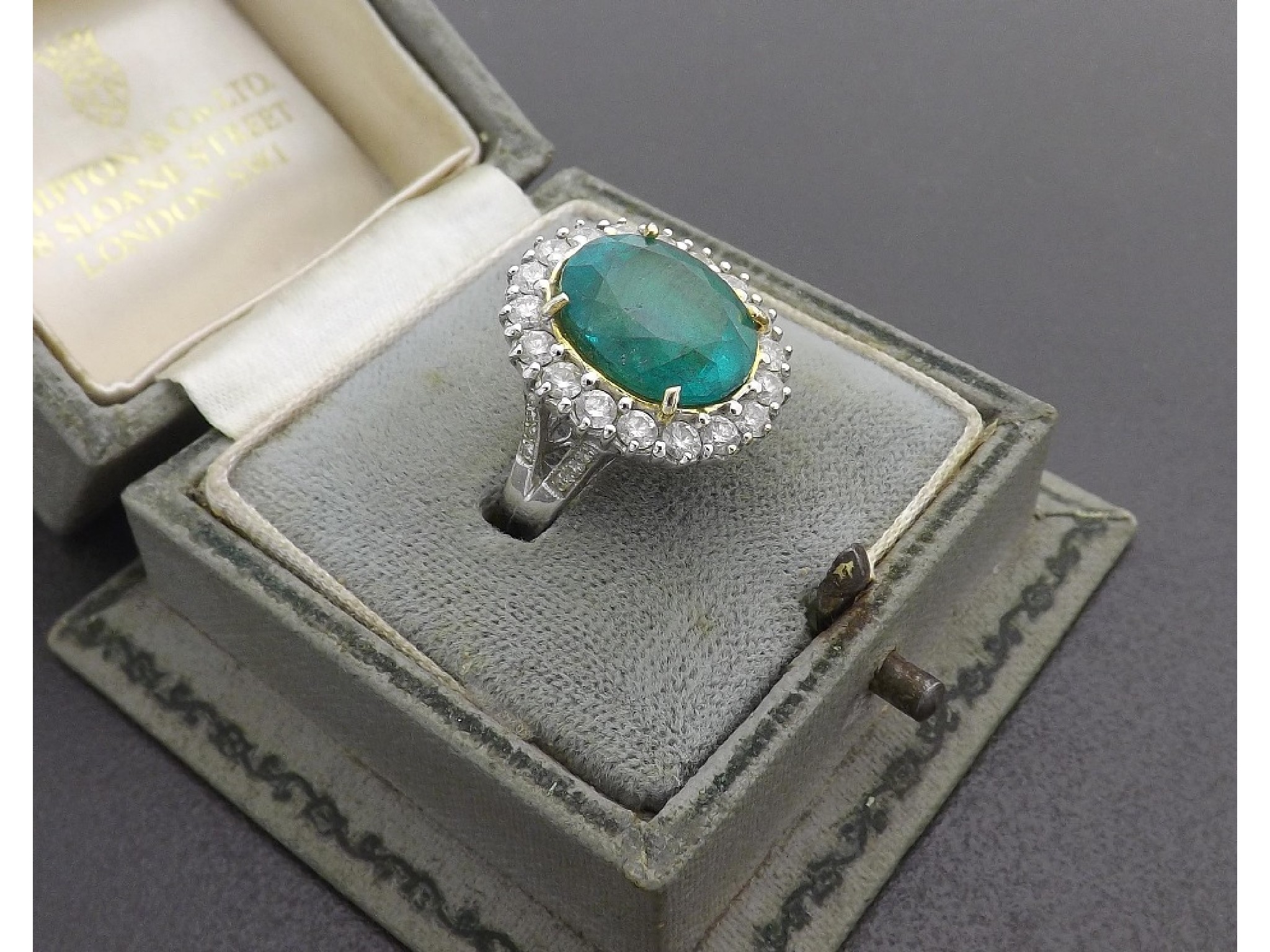 Appraisal: Good ct white gold emerald and diamond oval cluster ring