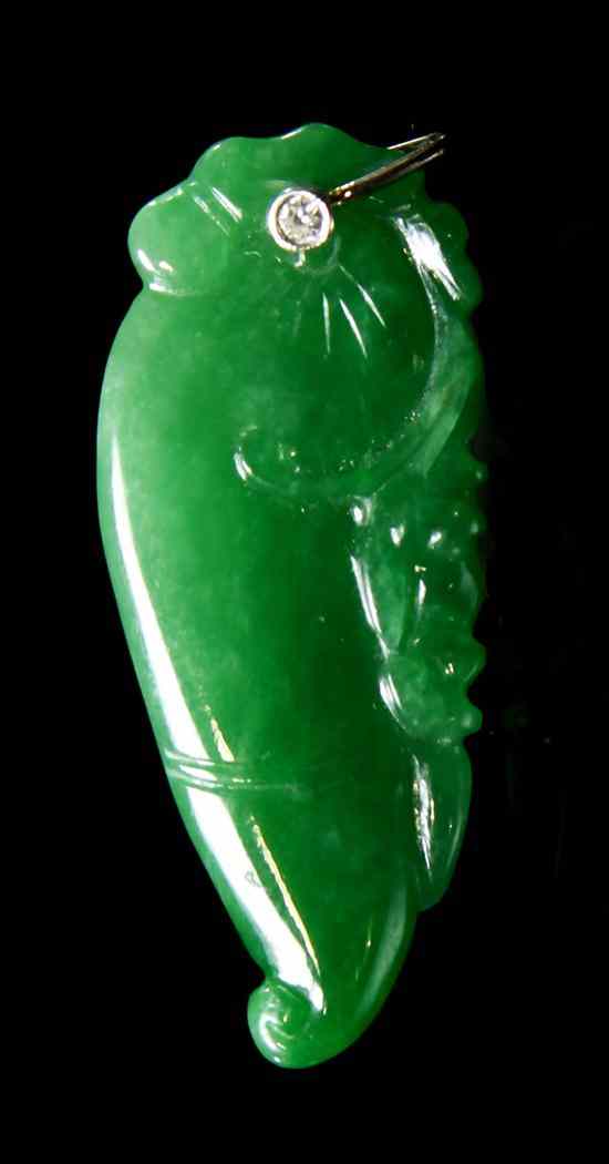 Appraisal: A Jadeite Amulet of semi-transparent emerald green colored stone in