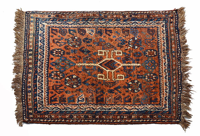 Appraisal: A SHIRAZ RUST GROUND MAT with central stylised medallion within