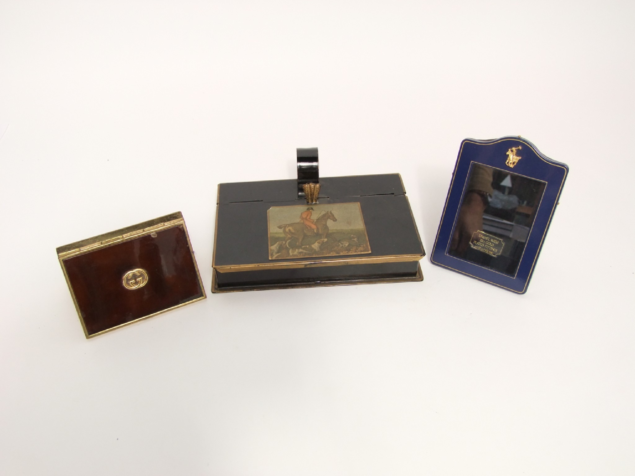 Appraisal: A small enamel photograph frame with polo mount Gucci cigarette