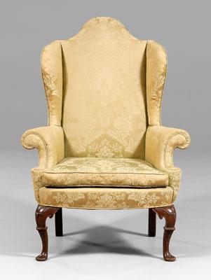 Appraisal: Irish Queen Anne style upholstered wing chair arched back and