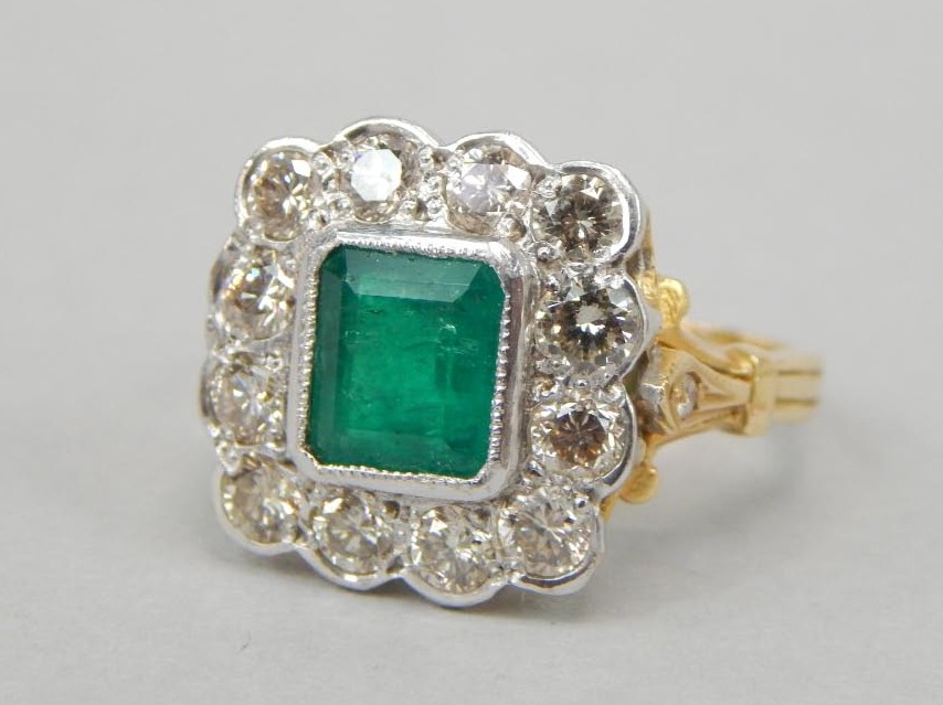 Appraisal: A dress ring central square emerald surrounded by white round