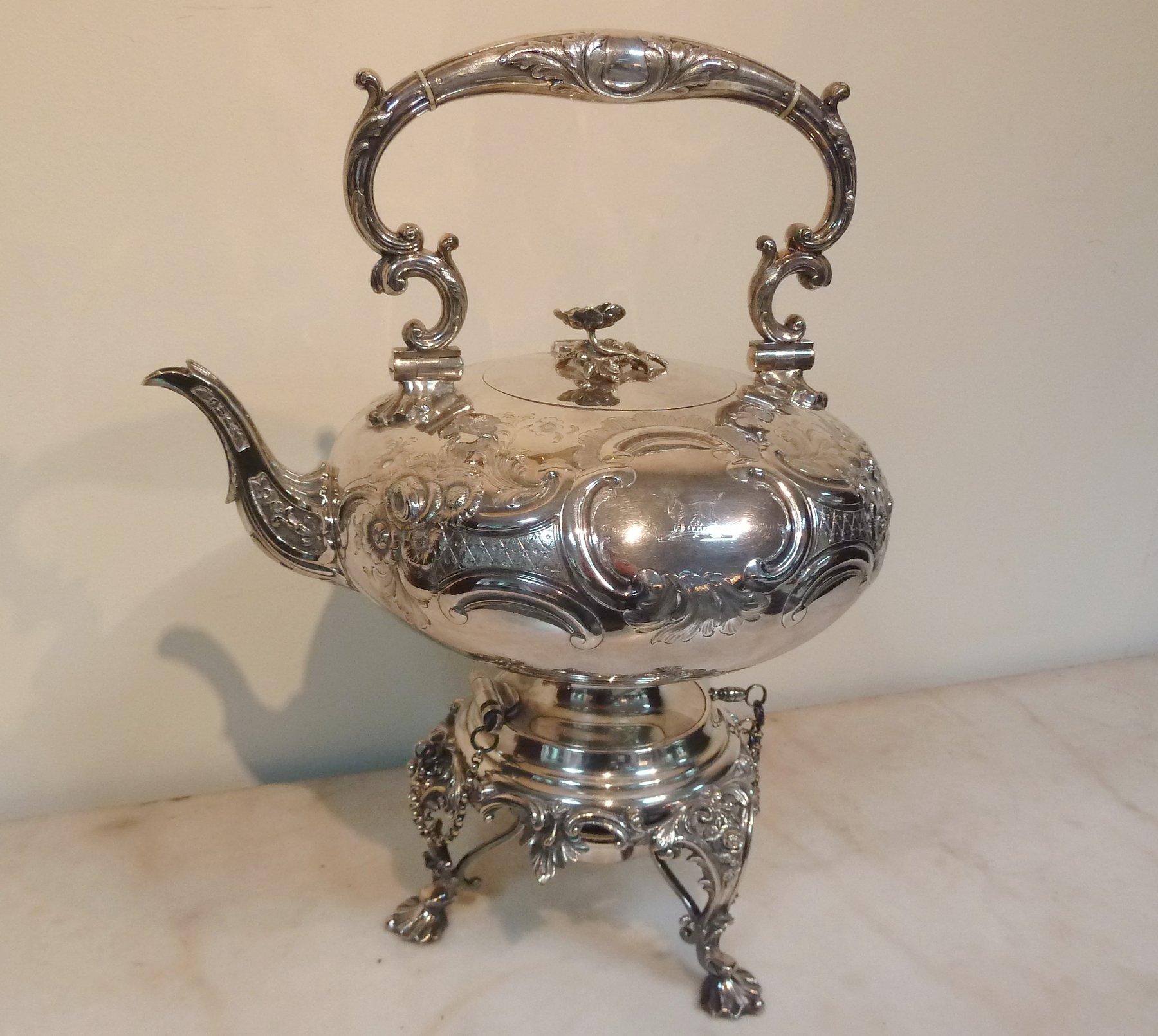 Appraisal: A silver plated Elkington Co spirit kettle on stand chased