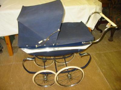 Appraisal: A Silver Cross doll's perambulator blue coach built with canvas