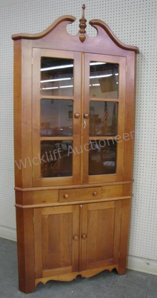 Appraisal: A vintage cherry corner cupboard with glass doors one drawer