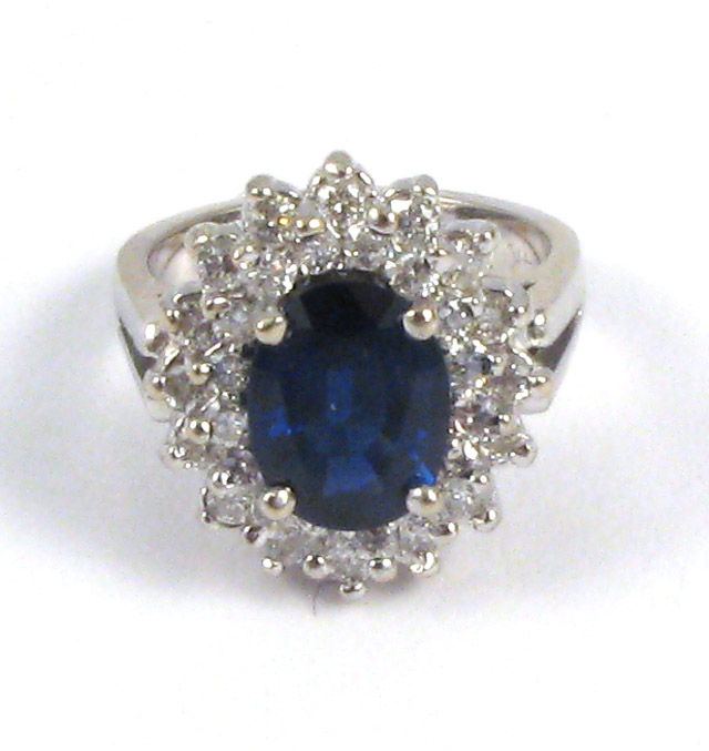 Appraisal: SAPPHIRE DIAMOND AND FOURTEEN KARAT GOLD DINNER RING Centered within