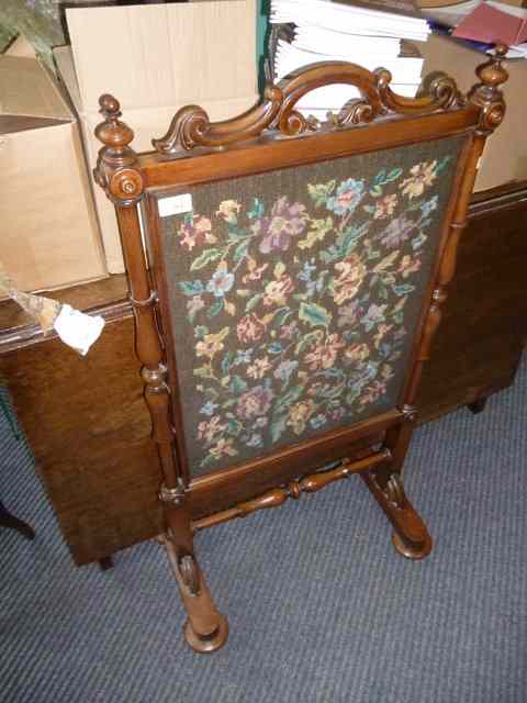 Appraisal: A VICTORIAN MAHOGANY FIRE SCREEN with turned supports and embroidered