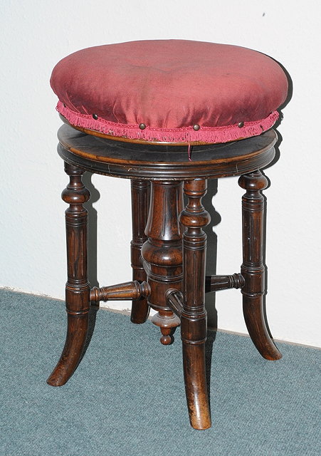 Appraisal: A TH CENTURY ROSEWOOD REVOLVING PIANO STOOL on fluted supports