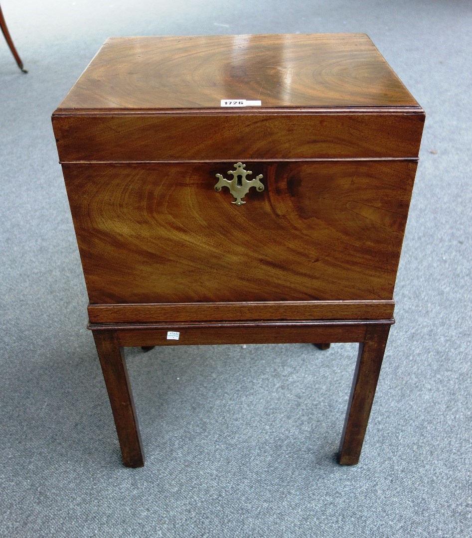 Appraisal: A George III mahogany cellarette the rectangular lift top revealing