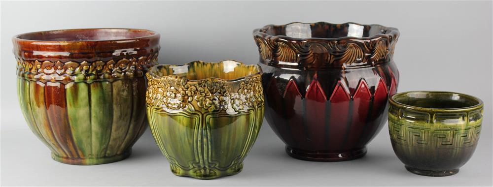 Appraisal: FOUR ART POTTERY JARDINIERES one with flared wave molded lip