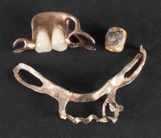 Appraisal: Two gold dental accessories together with one gilt-metal dental accessory