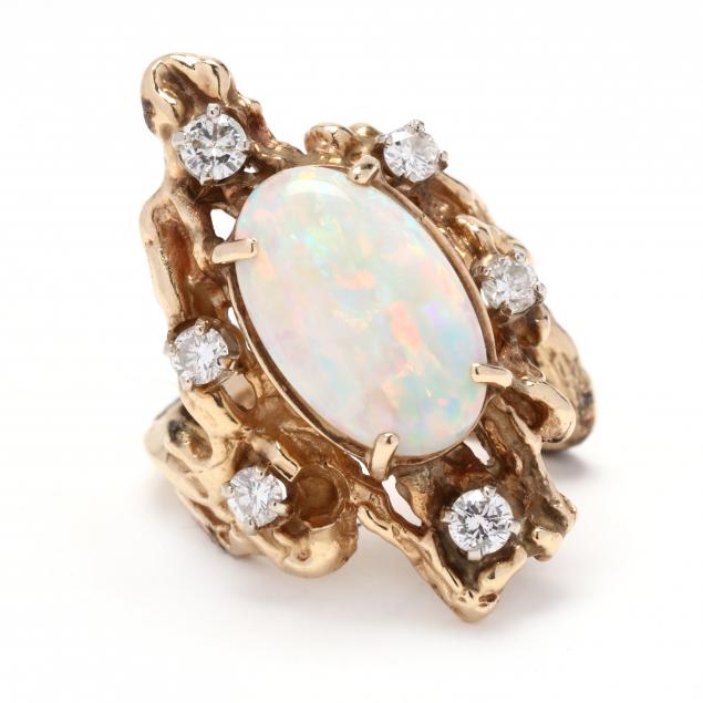 Appraisal: GOLD OPAL AND DIAMOND RING Centered on an oval cabochon