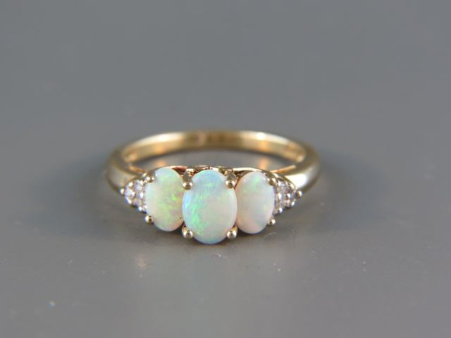 Appraisal: Opal and Diamond Ring a trio of fiery oval gems