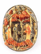 Appraisal: A finely carved Chinese stained ivory brooch in a white