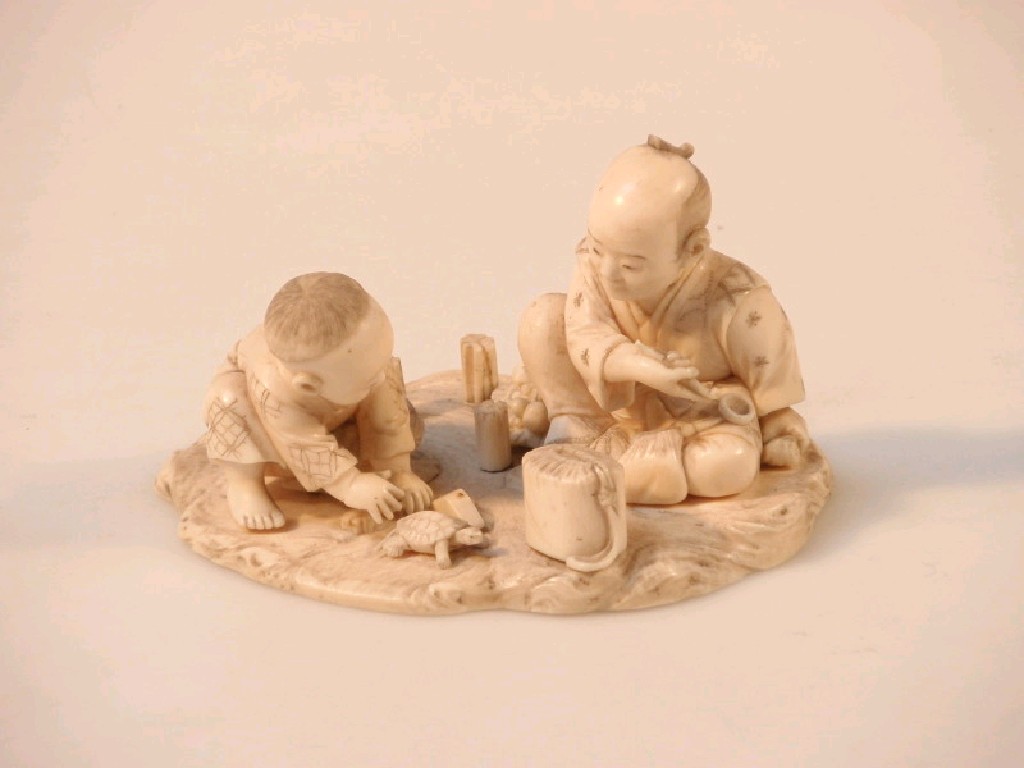 Appraisal: A thC Japanese carved ivory figure group of a man