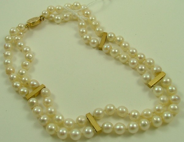 Appraisal: PEARL NECKLACE a double strand of round semi-baroque pearls with