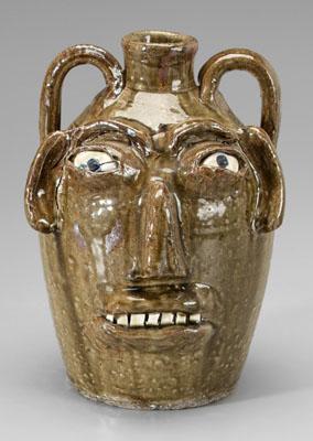 Appraisal: B B Craig stoneware face jug runny medium olive alkaline