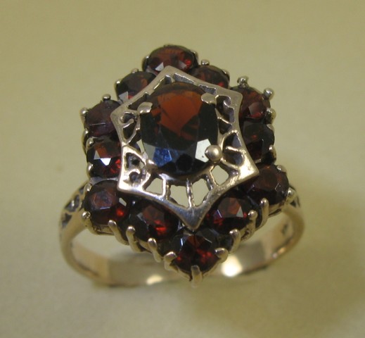 Appraisal: RED GARNET AND FOURTEEN KARAT GOLD RING the hexagonal setting