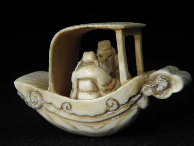 Appraisal: Chinese carved ivory netsuke depicting two figures in a dragon