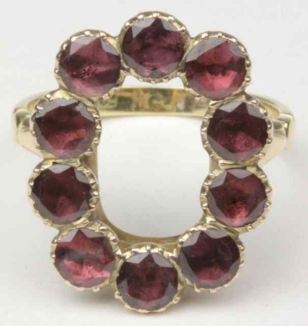 Appraisal: A Georgian ring set with flat-cut foil-backed garnets on a