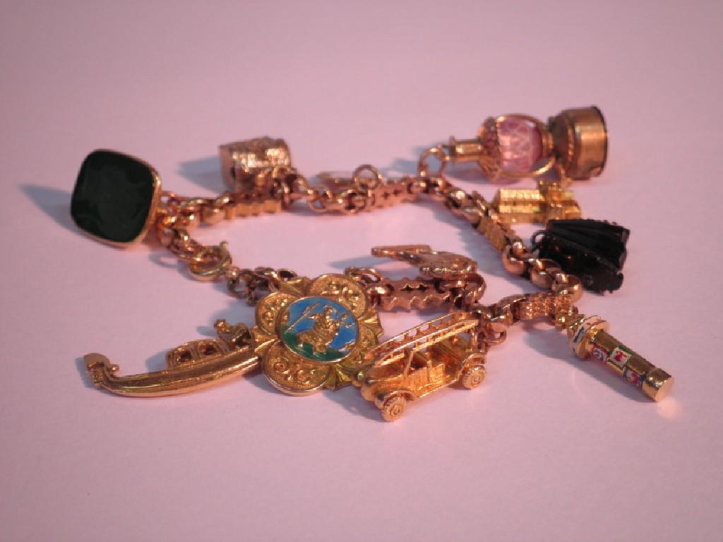 Appraisal: A converted watch chain bracelet with attached charms mostly ct