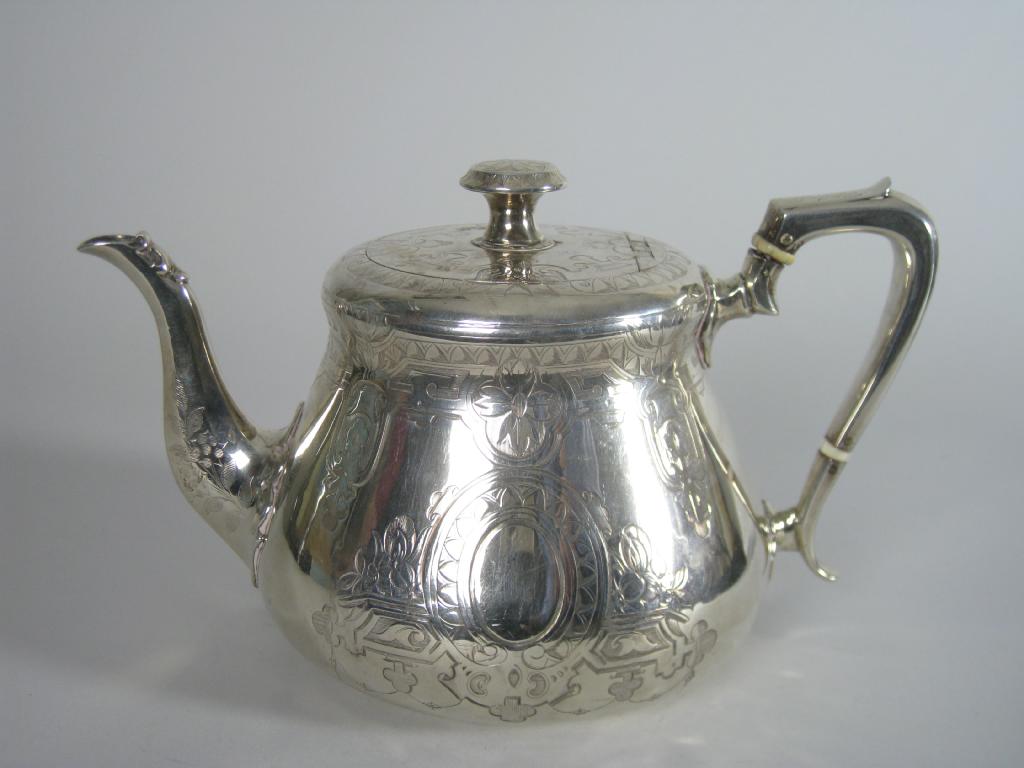 Appraisal: A Victorian circular Teapot with engraved decoration and vacant oval