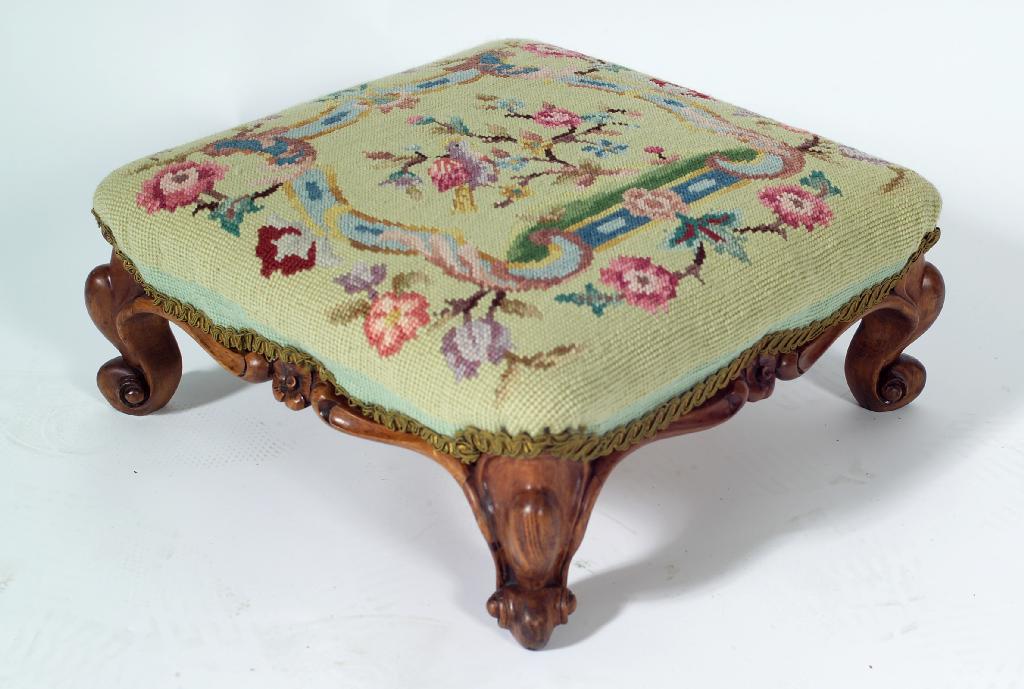 Appraisal: VICTORIAN WALNUT FOOTSTOOL the later needlework seat above a flower