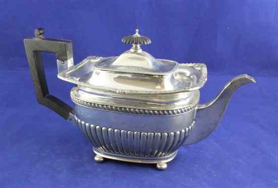 Appraisal: An Edwardian demi fluted silver teapot of rounded rectangular form