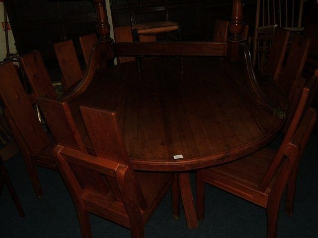 Appraisal: A 's circular pine table with seven associated chairs made