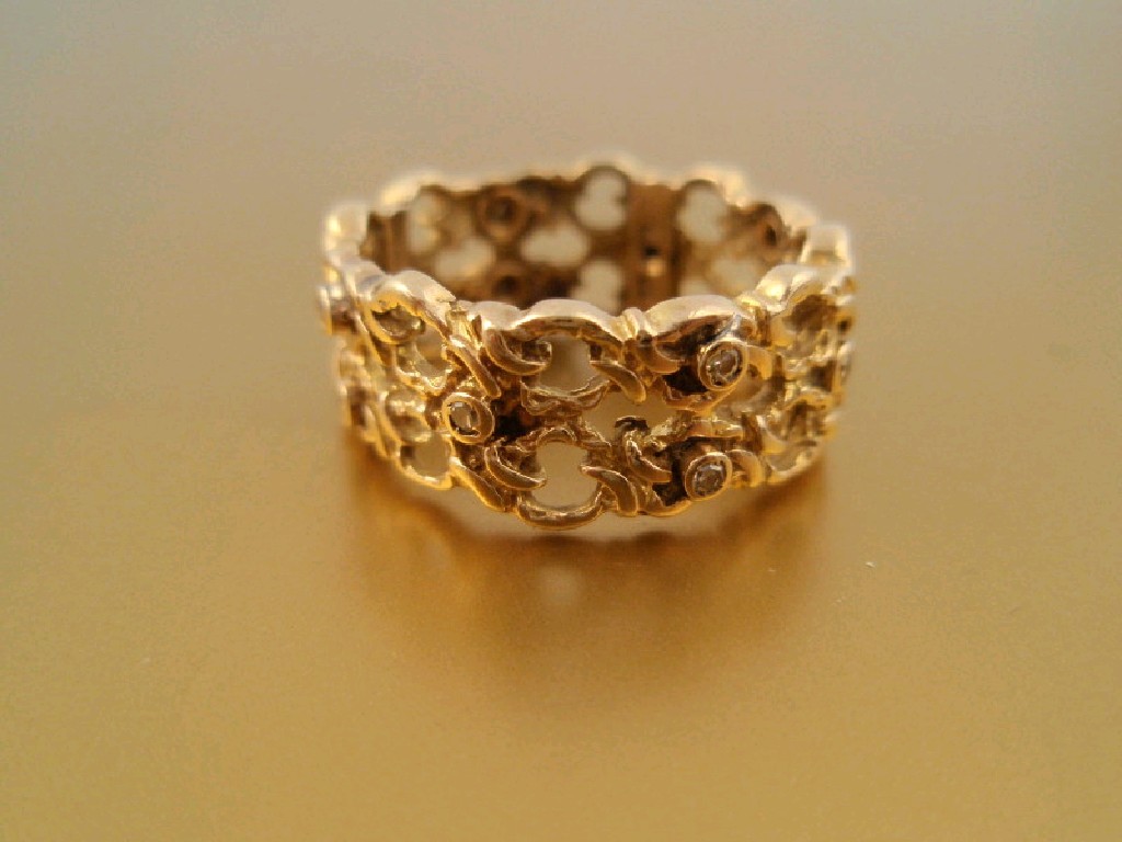 Appraisal: A ct gold filigree band with randomly set small diamonds