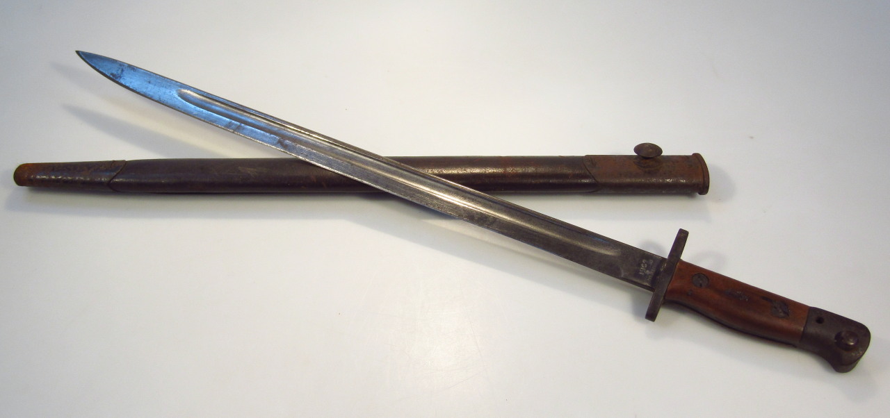 Appraisal: A Wilkinson bayonet and scabbard with metal mounts the wooden