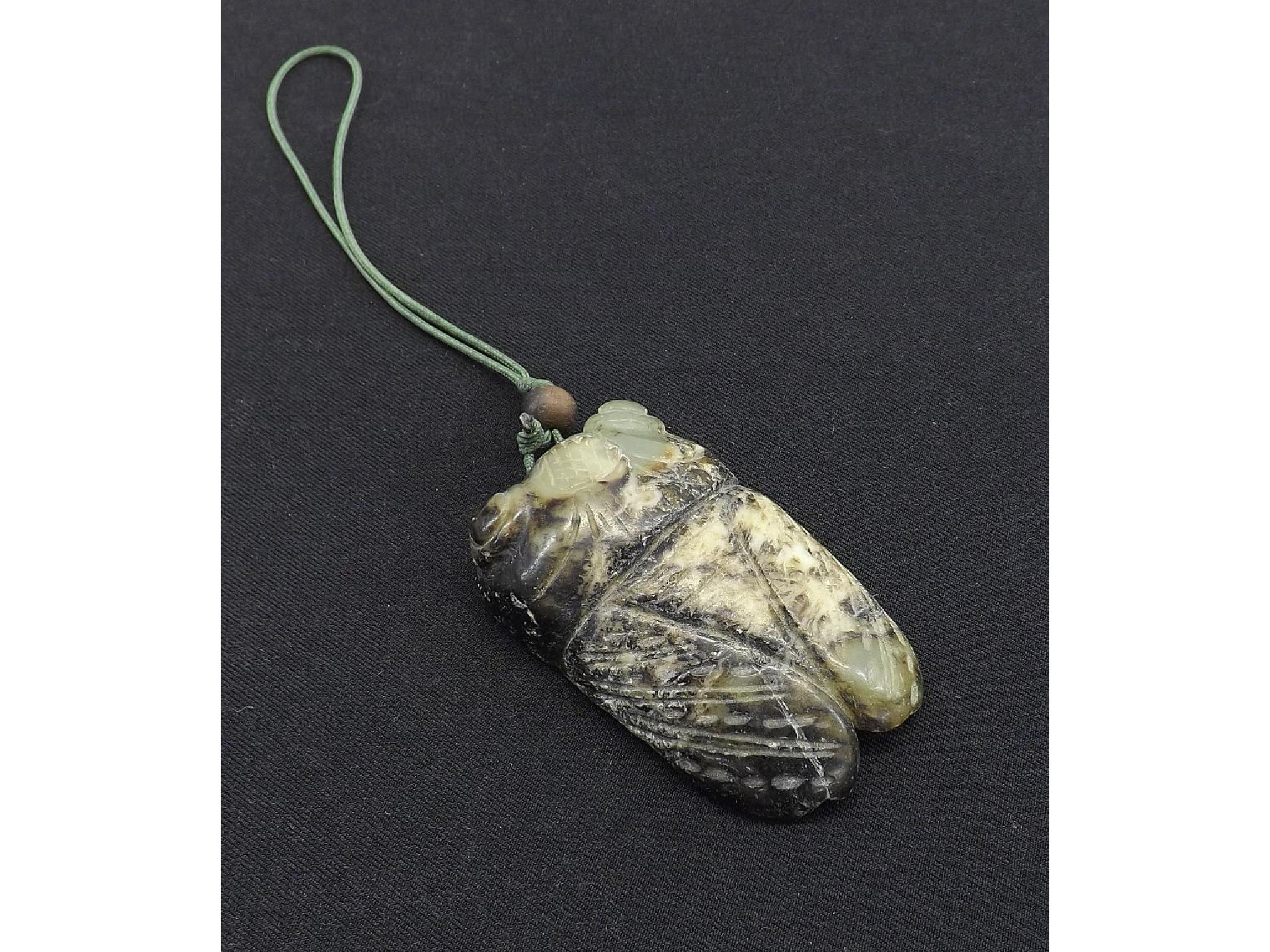 Appraisal: Celadon white and dark carved jade modelled as a cicada