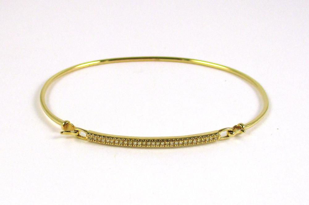 Appraisal: DIAMOND AND FOURTEEN KARAT GOLD BANGLE The oval yellow gold