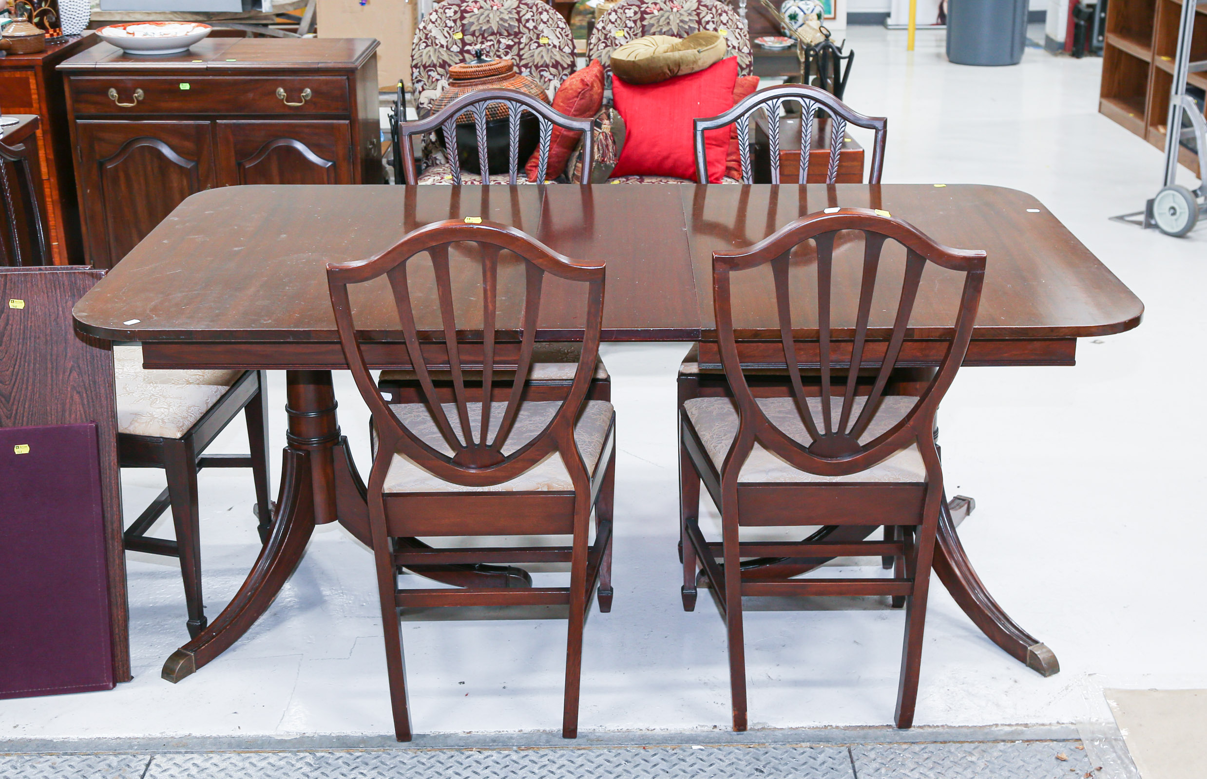 Appraisal: REGENCY STYLE MAHOGANY DINING TABLE CHAIRS Comprising a double pedestal