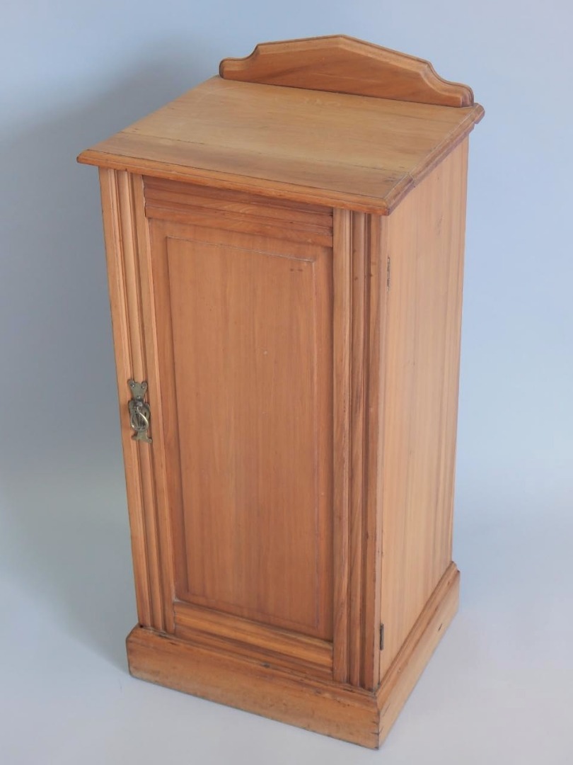 Appraisal: A stripped Victorian walnut bedside cabinet with a single panelled