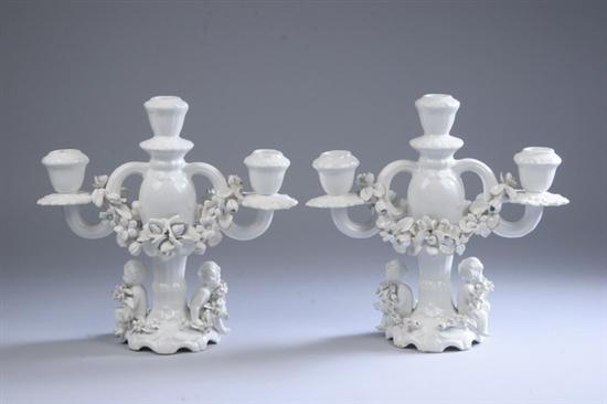 Appraisal: PAIR FRENCH FA ENCE FIGURAL THREE-LIGHT CANDELABRA early th century