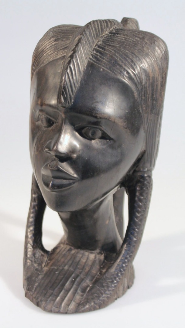 Appraisal: A thC African tribal hardwood head carved in the form