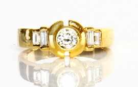 Appraisal: An ct gold round brilliant cut diamond solitaire with baguette