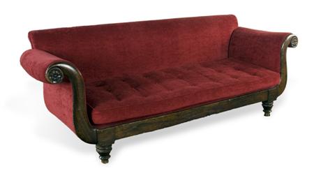 Appraisal: A Victorian simulated rosewood sofa the scroll back over matching