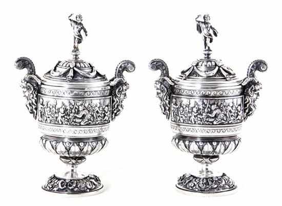 Appraisal: Pair Continental silverplate covered urns intricate Bacchanalian scenic band on