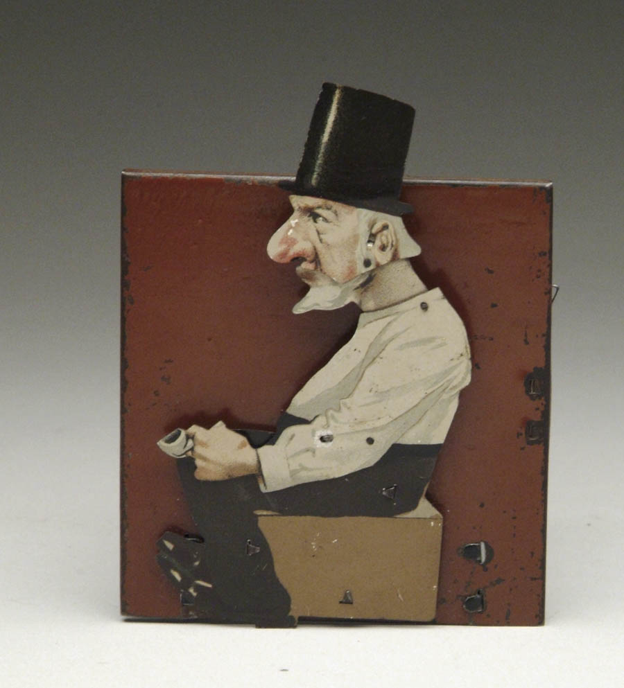 Appraisal: MAN DRINKING CLOCKWORK TOY Of German manufacture Lithographed man sitting