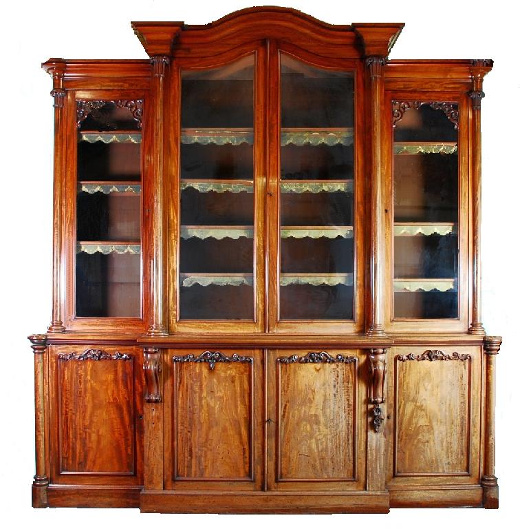 Appraisal: IMPRESSIVE VICTORIAN CARVED MAHOGANY BREAKFRONT LIBRARY BOOKCASE the arched moulded