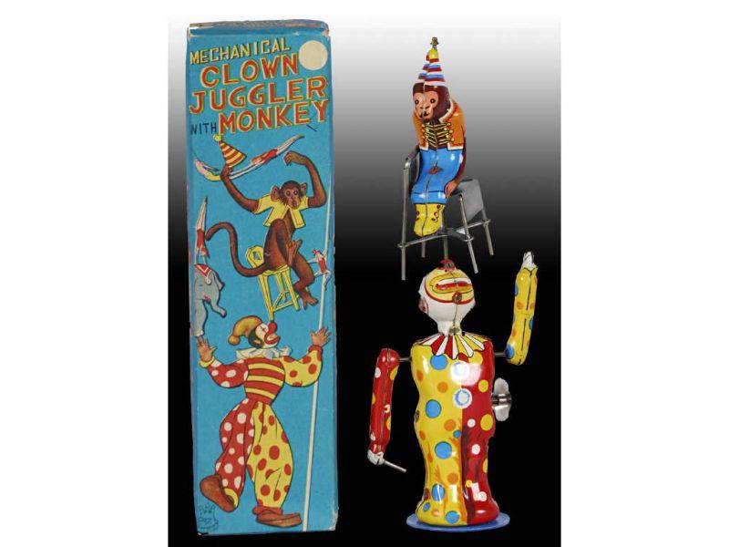 Appraisal: Japanese TPS Tin Wind-Up Clown Juggling Monkey Toy Description ''