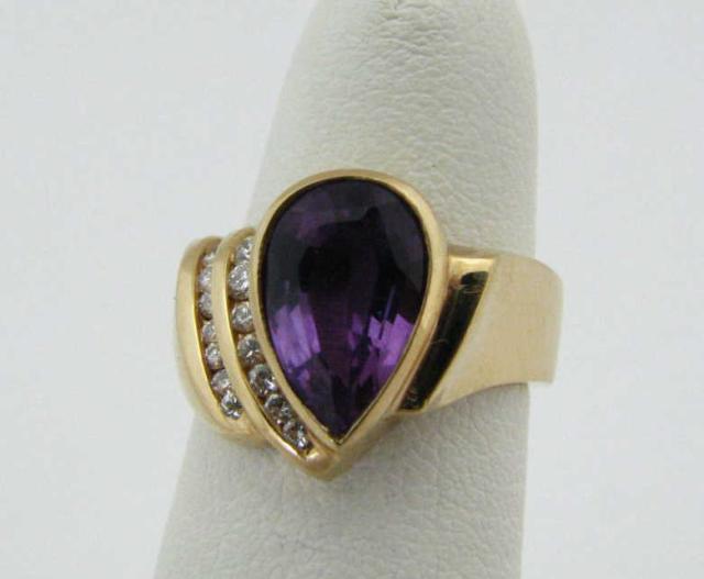 Appraisal: K Yellow gold ring with pave mounted pear shaped amethyst