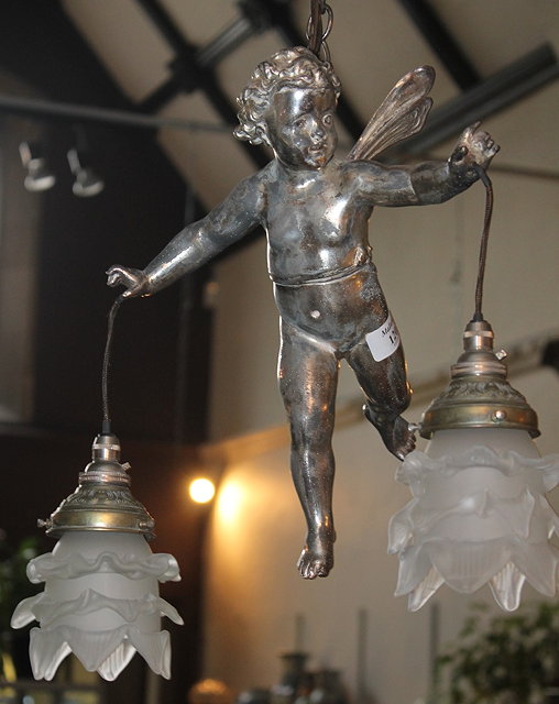 Appraisal: A HANGING LIGHT in the form of a silvered cupid