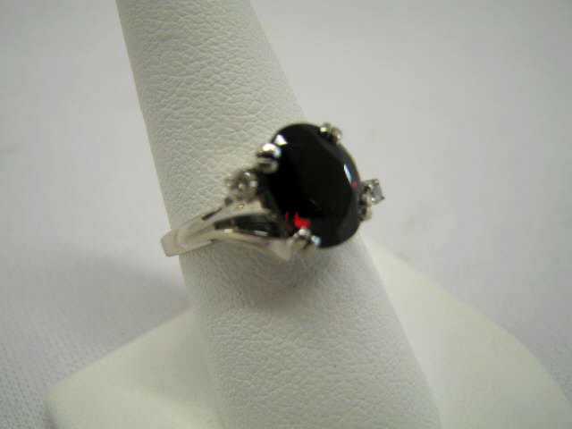 Appraisal: Garnet Diamond Ring rich oval gem with small diamond on