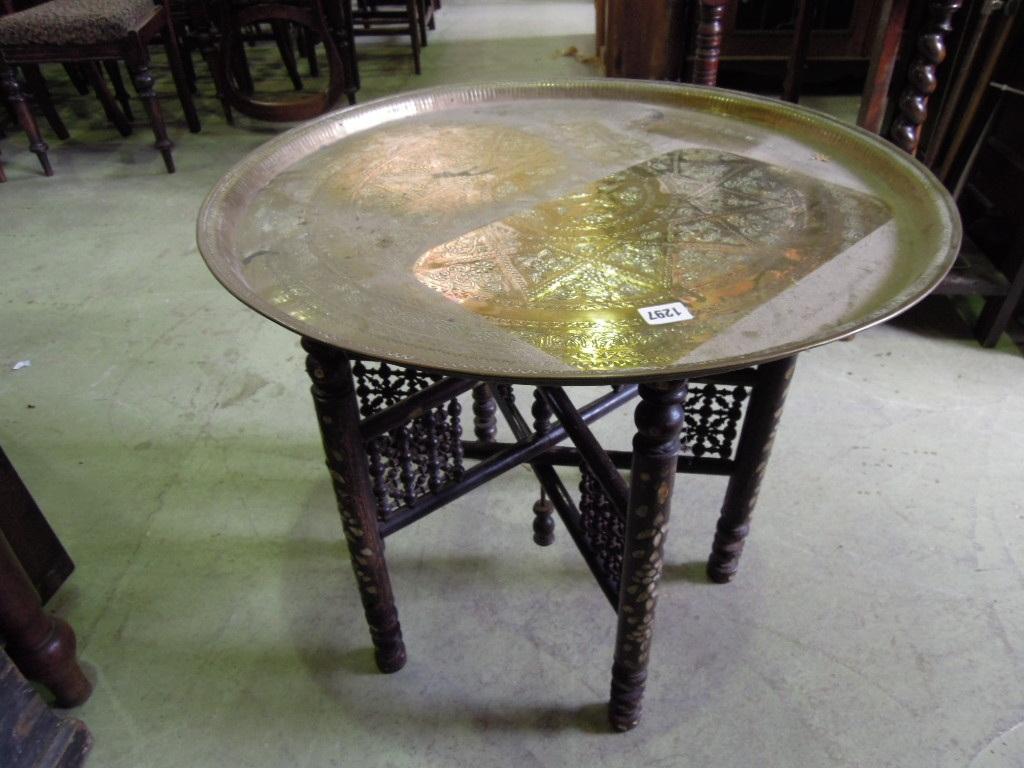 Appraisal: A Benares brass tray top occasional table of circular form