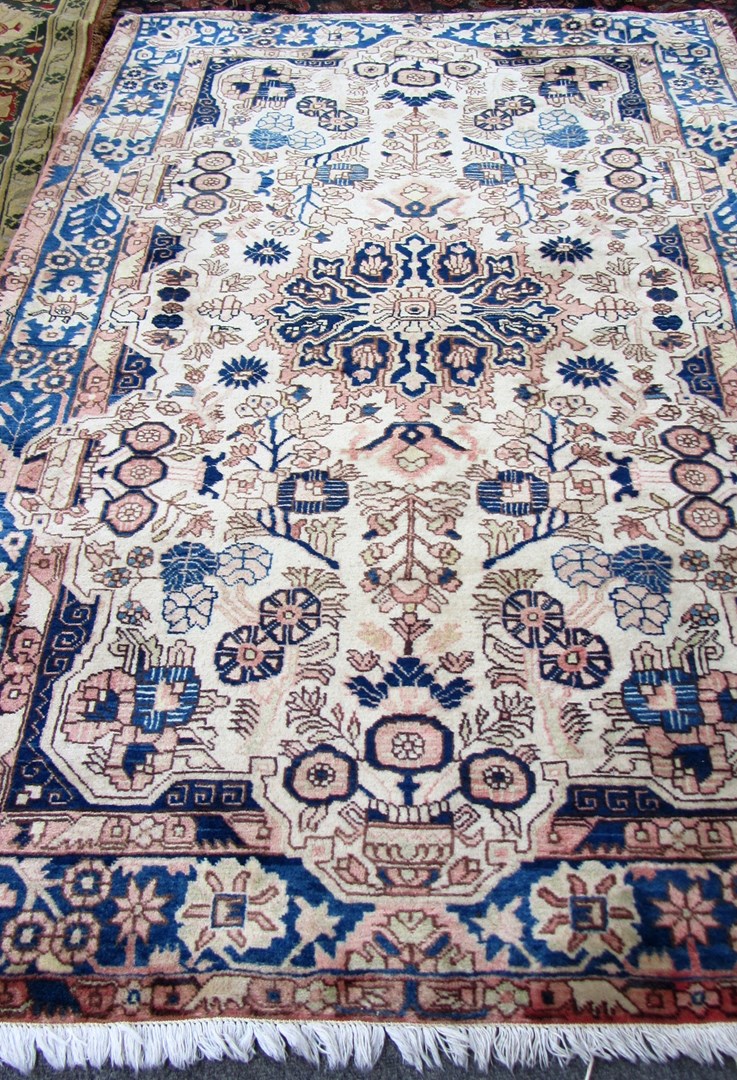 Appraisal: A Sarough rug Persian the ivory field with an indigo